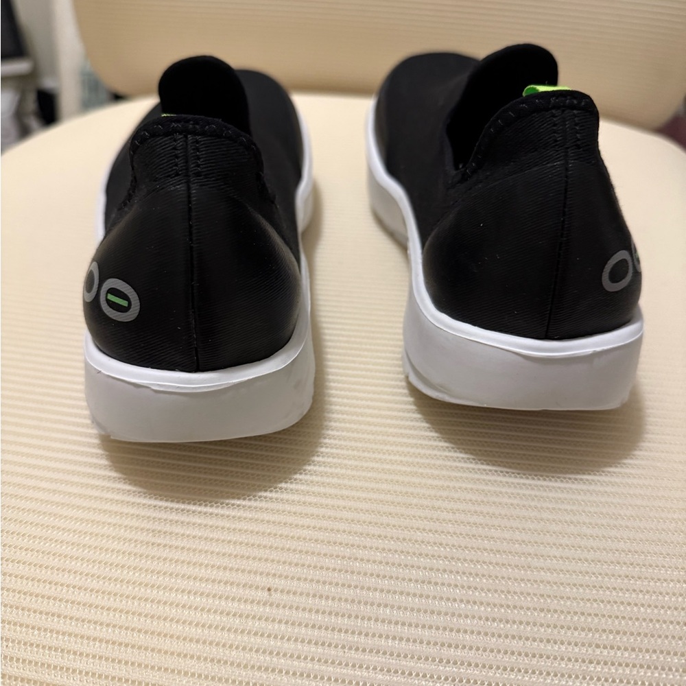 OOFOS Black and White Womens slip on sneakers